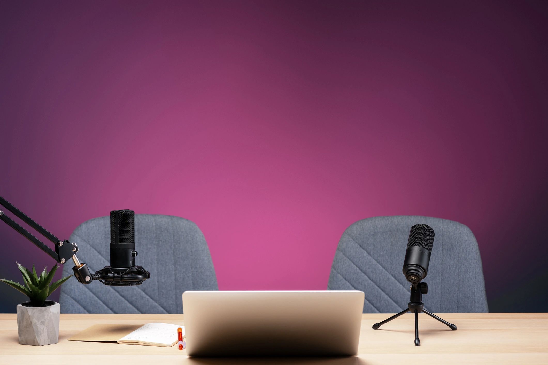 Podcast studio with microphones and bourbon glasses